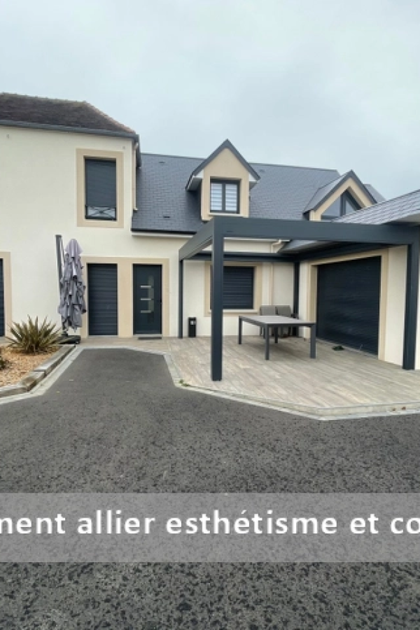 Maison crème avec pergola anthracite sur terrasse carrelée, menuiseries et porte garage assorties