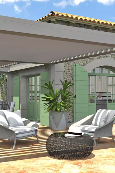 Pergola bioclimatique grise avec lames ouvertes, salon tressé blanc devant maison pierre