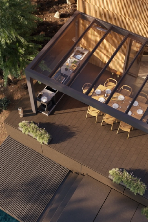Vue plongeante pergola toit verre avec cuisine extérieure, table à manger et bardage bois