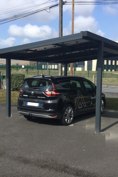 Voiture sous carport aluminium anthracite équipé de panneaux solaires sur le toit