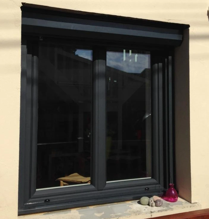 Fenêtre double anthracite, coffre volet roulant intégré, crépi crème, galets sur appui